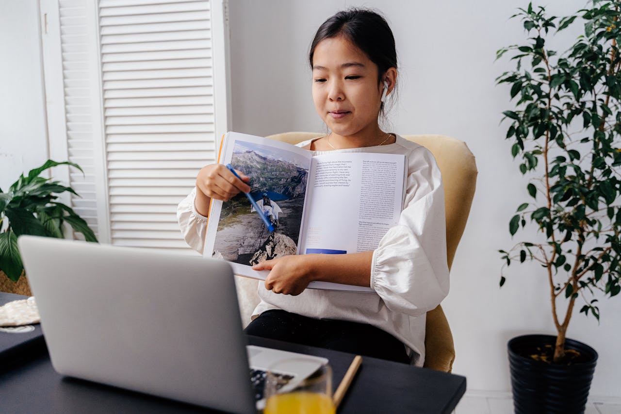 A young girl interacting with an online learning session at home, showcasing technology in education.